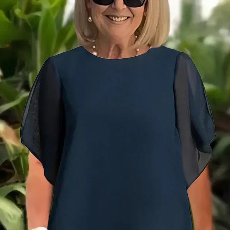 Charmerende sæt med uregelmæssig top og bukser med brede ben – asymmetrisk kant, flagrende dobbeltlag og elegance hele dagen 👗✨