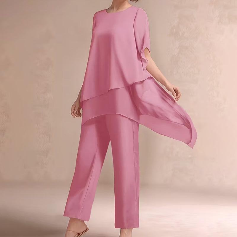 Charmerende sæt med uregelmæssig top og bukser med brede ben – asymmetrisk kant, flagrende dobbeltlag og elegance hele dagen 👗✨