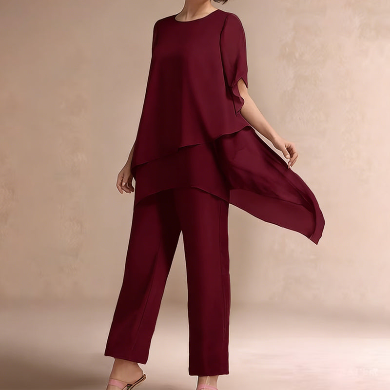 Charmerende sæt med uregelmæssig top og bukser med brede ben – asymmetrisk kant, flagrende dobbeltlag og elegance hele dagen 👗✨