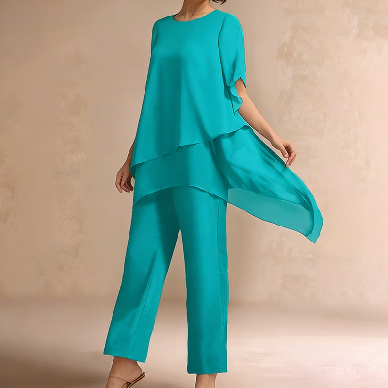 Charmerende sæt med uregelmæssig top og bukser med brede ben – asymmetrisk kant, flagrende dobbeltlag og elegance hele dagen 👗✨