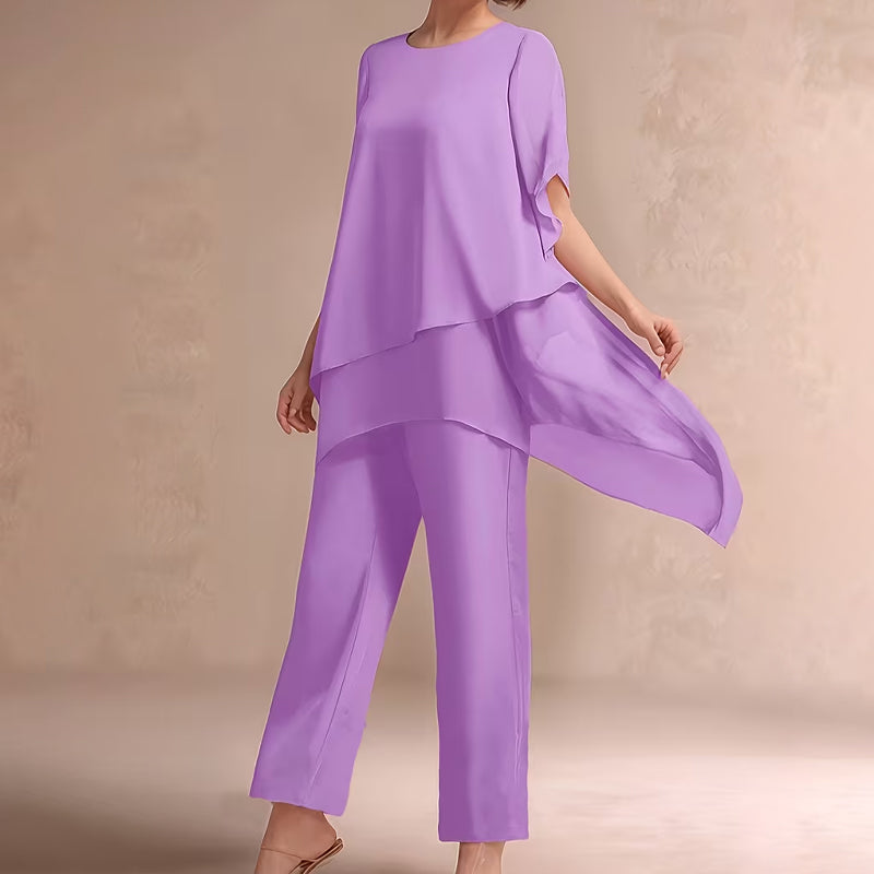 Charmerende sæt med uregelmæssig top og bukser med brede ben – asymmetrisk kant, flagrende dobbeltlag og elegance hele dagen 👗✨